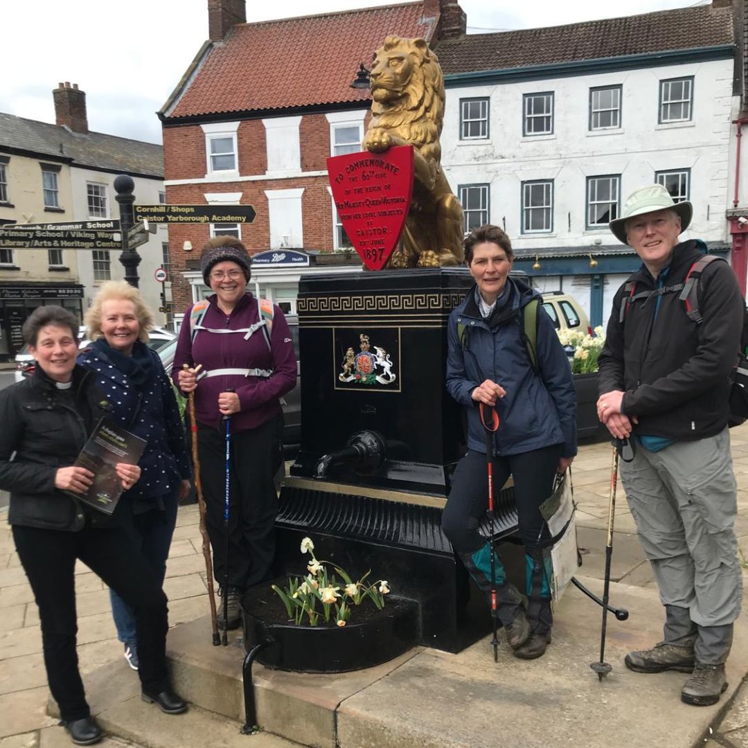 Viking Way Walk 2024 Day 2 at Caistor Various walkers next to a lion monument.